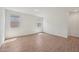 Bright bedroom with wood look flooring and two sunny windows at 9547 W Parkway Dr, Tolleson, AZ 85353