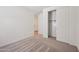 Cozy bedroom featuring neutral carpet, closet, and light-filled entryway at 9547 W Parkway Dr, Tolleson, AZ 85353
