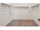 Empty closet with bars for hanging clothing and carpet flooring at 9547 W Parkway Dr, Tolleson, AZ 85353