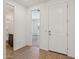 An interior shot of the home's foyer with white walls and a white front door at 9547 W Parkway Dr, Tolleson, AZ 85353