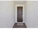 An exterior shot showing the home's front door, framed by white walls at 9547 W Parkway Dr, Tolleson, AZ 85353