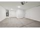 Clean and spacious two car garage with neutral color paint and concrete flooring at 9547 W Parkway Dr, Tolleson, AZ 85353