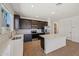 Bright, open kitchen featuring stainless appliances, dark cabinets, and tile backsplash at 9547 W Parkway Dr, Tolleson, AZ 85353