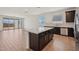 Contemporary kitchen boasts a large island, sleek countertops, dark cabinets, and stainless steel appliances at 9547 W Parkway Dr, Tolleson, AZ 85353