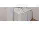 White laundry machines are installed in the home on wood look flooring at 9547 W Parkway Dr, Tolleson, AZ 85353
