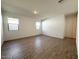Spacious and bright living room with tile flooring and two windows at 9547 W Parkway Dr, Tolleson, AZ 85353