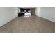 Open-concept living space with tile floors connecting to the kitchen at 9547 W Parkway Dr, Tolleson, AZ 85353