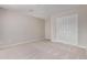 This bedroom has neutral walls and carpet and a built-in closet at 10225 W Camelback Rd # 3, Phoenix, AZ 85037