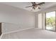 This bedroom has neutral walls and carpet and balcony access at 10225 W Camelback Rd # 3, Phoenix, AZ 85037