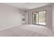 This bedroom has neutral walls and carpet and balcony access at 10225 W Camelback Rd # 3, Phoenix, AZ 85037