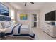 Bedroom with a queen sized bed, dresser, and view into the ensuite bathroom at 10225 W Camelback Rd # 3, Phoenix, AZ 85037