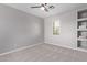 This bedroom has neutral walls and carpet and a ceiling fan at 10225 W Camelback Rd # 3, Phoenix, AZ 85037