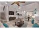 Sunlit living room featuring a modern ceiling fan, wood floors, and combined kitchen and dining area at 10225 W Camelback Rd # 3, Phoenix, AZ 85037