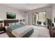 This main bedroom has soft carpet, balcony access, and calming tones at 10225 W Camelback Rd # 3, Phoenix, AZ 85037