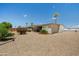 Serene backyard showcases desert landscaping with lush bushes and mature orange tree providing a private outdoor space at 10429 W Oakmont Dr, Sun City, AZ 85351