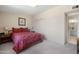 Bedroom features patterned bedding, side tables and convenient access to the bathroom at 10429 W Oakmont Dr, Sun City, AZ 85351