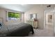 Bright bedroom with dresser storage and closet, featuring a grey bed set and bright window at 10429 W Oakmont Dr, Sun City, AZ 85351