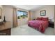 Comfortable bedroom features a bright window and patterned bedspread at 10429 W Oakmont Dr, Sun City, AZ 85351
