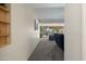 Hallway with carpet flooring that leads to living area with large sliding glass doors at 10429 W Oakmont Dr, Sun City, AZ 85351