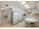Bright kitchen with tile flooring, a white appliance suite, and a cozy breakfast nook perfect for casual dining at 10429 W Oakmont Dr, Sun City, AZ 85351