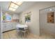 Bright kitchen with tile flooring and a cozy breakfast nook, offering a delightful view of the outdoors at 10429 W Oakmont Dr, Sun City, AZ 85351