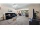 Spacious living room features plush carpeting and comfortable seating that offers plenty of room for entertaining at 10429 W Oakmont Dr, Sun City, AZ 85351