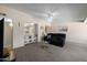 Spacious living room features plush carpeting and comfortable seating along with open access to the kitchen at 10429 W Oakmont Dr, Sun City, AZ 85351