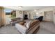 Inviting living room features neutral carpet, a large window, and comfortable striped sofas at 10429 W Oakmont Dr, Sun City, AZ 85351