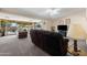 Spacious living room featuring plush carpeting, fan, recessed lighting and a sliding glass door to the exterior at 10429 W Oakmont Dr, Sun City, AZ 85351