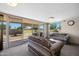 Spacious living room featuring plush carpeting and a sliding glass door to the exterior at 10429 W Oakmont Dr, Sun City, AZ 85351