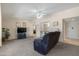 Spacious living room features plush carpeting, fan, recessed lighting, a television, and comfortable seating at 10429 W Oakmont Dr, Sun City, AZ 85351
