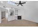 Living room featuring vaulted ceilings, fan, fireplace, and an open view of the bar and kitchen at 1126 W Elliot Rd # 2040, Chandler, AZ 85224