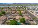 Aerial image shows the community neighborhood, mature trees, solar panels, and backyard swimming pools at 11359 E Elena Ave, Mesa, AZ 85208