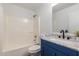 Clean bathroom featuring a shower and tub combination, vanity with granite counters and blue cabinets at 11359 E Elena Ave, Mesa, AZ 85208