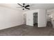 Spacious carpeted bedroom with a ceiling fan and closet space at 11359 E Elena Ave, Mesa, AZ 85208