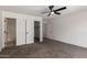 Well-lit carpeted bedroom showcasing closet and attached bathroom at 11359 E Elena Ave, Mesa, AZ 85208
