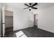 Stylish bedroom featuring sleek tiled flooring, ceiling fan, closet, and attached bathroom at 11359 E Elena Ave, Mesa, AZ 85208