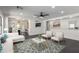 Airy living room with open layout, modern decor, and view to dining area and kitchen at 11359 E Elena Ave, Mesa, AZ 85208