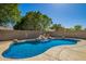 Beautiful backyard featuring a sparkling blue pool with a charming rock waterfall feature at 11359 E Elena Ave, Mesa, AZ 85208