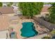 An aerial shot showcases a backyard pool, mature tree, and an appealing patio area at 11359 E Elena Ave, Mesa, AZ 85208