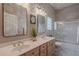 Bathroom with dual sinks, a shower over tub, and large mirrors at 11651 E Appaloosa Pl, Scottsdale, AZ 85259
