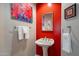 Stylish half-bath features modern fixtures and bold red accent wall at 11651 E Appaloosa Pl, Scottsdale, AZ 85259