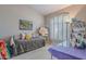 Bedroom with a trundle bed, window with plantation shutters, an easel, and a bookshelf at 11651 E Appaloosa Pl, Scottsdale, AZ 85259