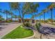 Beautifully landscaped community entrance with palm trees and a welcoming gate at 11651 E Appaloosa Pl, Scottsdale, AZ 85259
