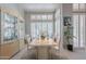 Elegant dining room with a modern table set, ample natural light, and stylish built-in display case at 11651 E Appaloosa Pl, Scottsdale, AZ 85259