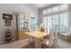 Elegant dining room featuring a display cabinet, stylish table set, and natural light at 11651 E Appaloosa Pl, Scottsdale, AZ 85259