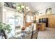 View of the kitchen and dining area with sliding doors that lead to the backyard pool at 11651 E Appaloosa Pl, Scottsdale, AZ 85259