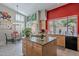 Kitchen island with cooktop, granite counters, view to the backyard pool and dining area at 11651 E Appaloosa Pl, Scottsdale, AZ 85259