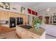 Gourmet kitchen with granite counters, stainless steel appliances, and cooktop island at 11651 E Appaloosa Pl, Scottsdale, AZ 85259