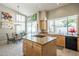 Bright kitchen with island, gas cooktop, modern appliances, and adjacent dining area at 11651 E Appaloosa Pl, Scottsdale, AZ 85259